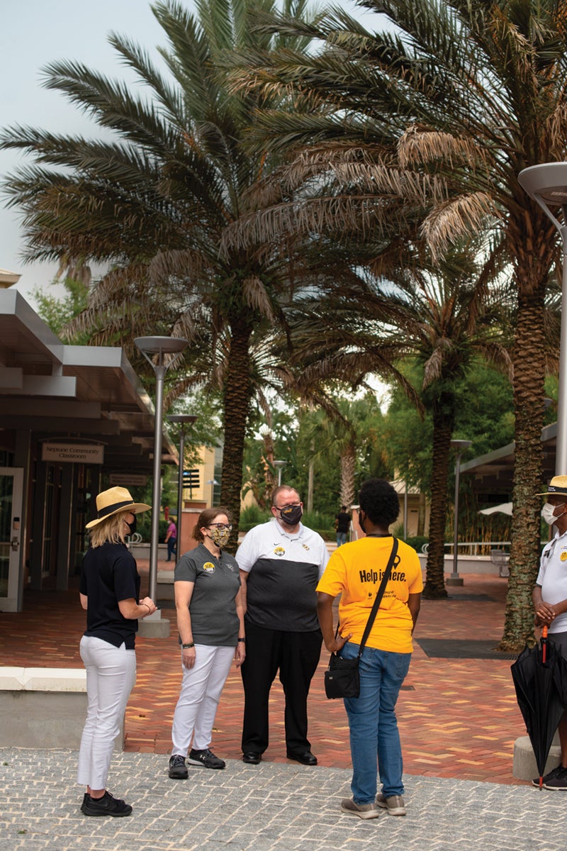 Alexander and Melinda Cartwright speak to students near student housing