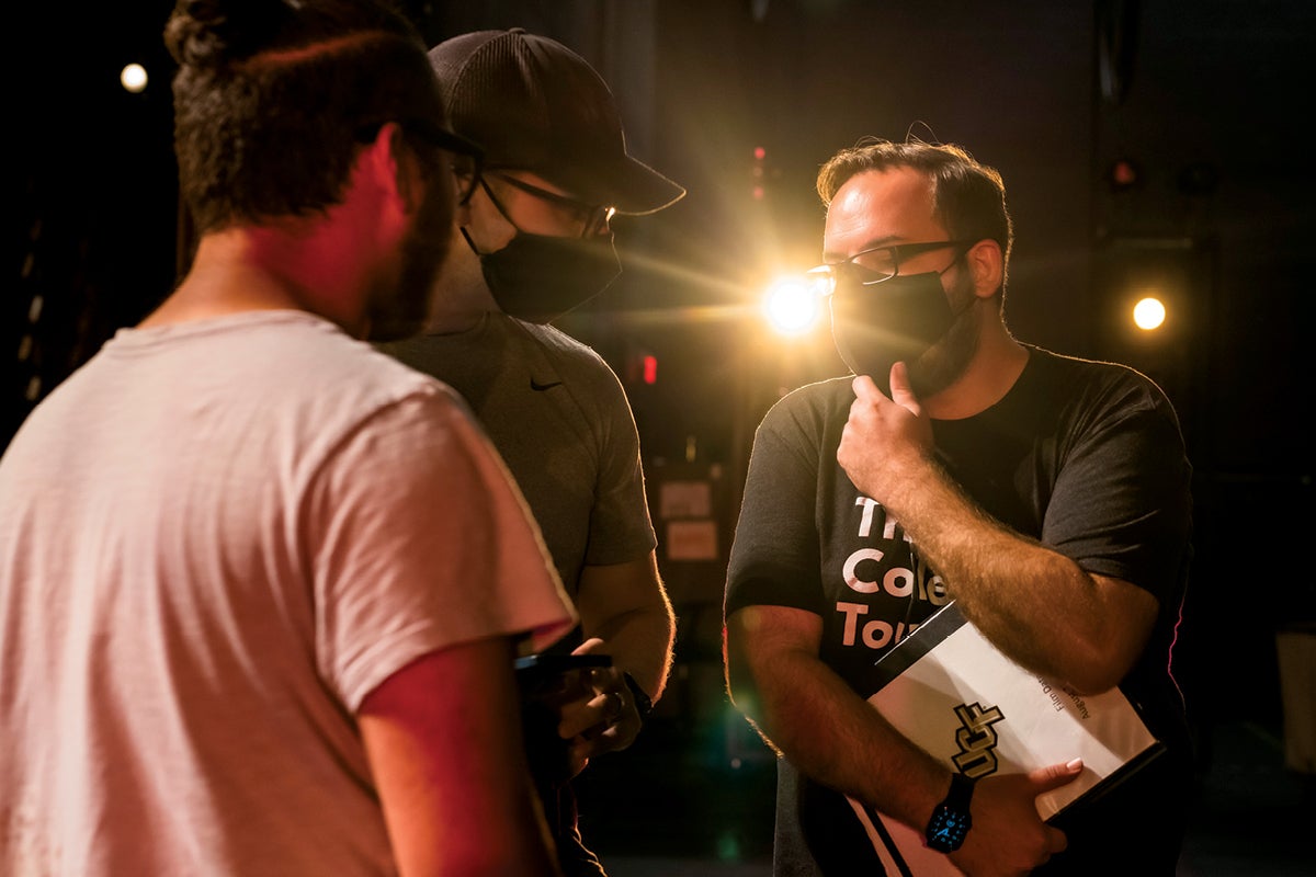 Martin Olarte (right) strategizes with the crew behind the scenes at the Dr. Phillips Center for the Performing Arts