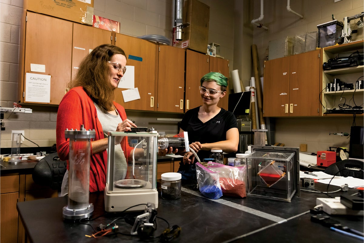 Addie Dove works with an extra in a lab