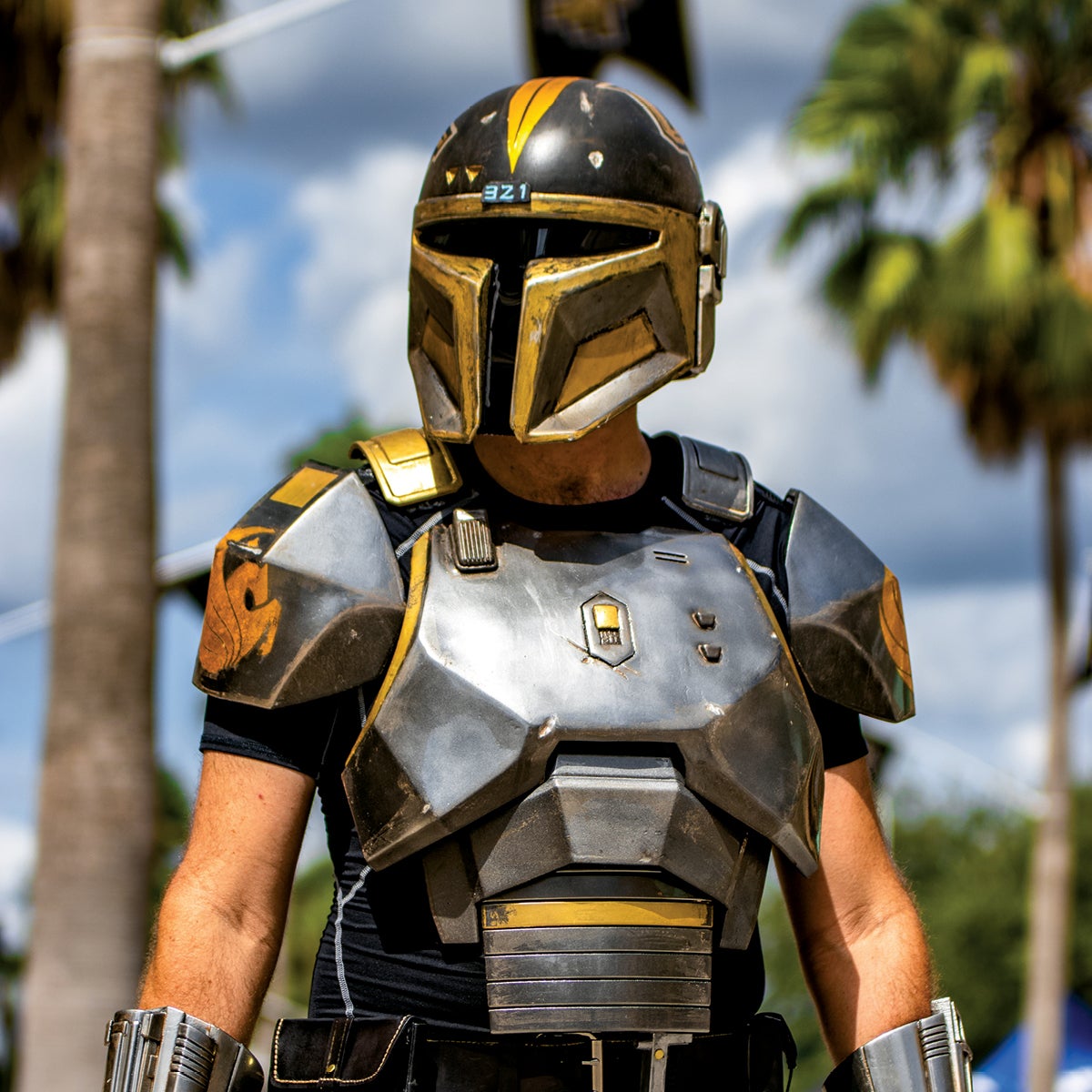 A fan wears a Knight helmet and armor