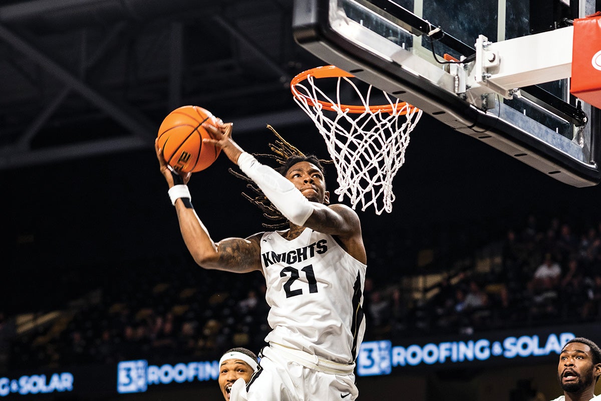 A basketball player prepares to dunk a ball.