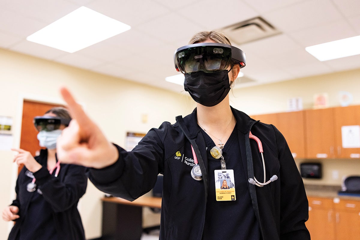 Two students wearing virtual reality headsets.