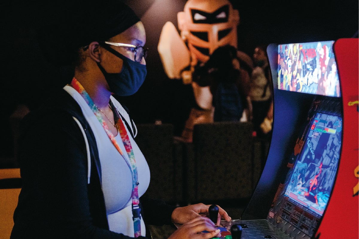 A student playing an arcade game.