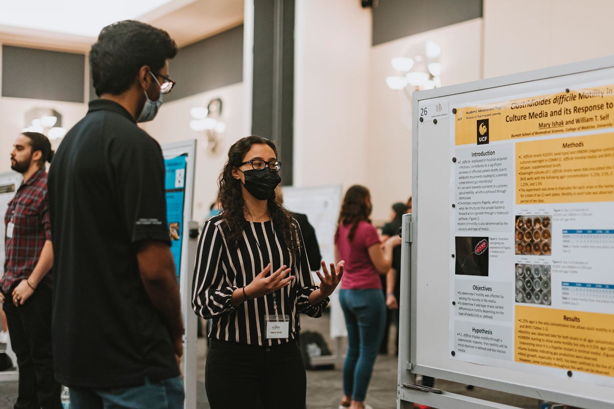 A student explaining their research to someone.