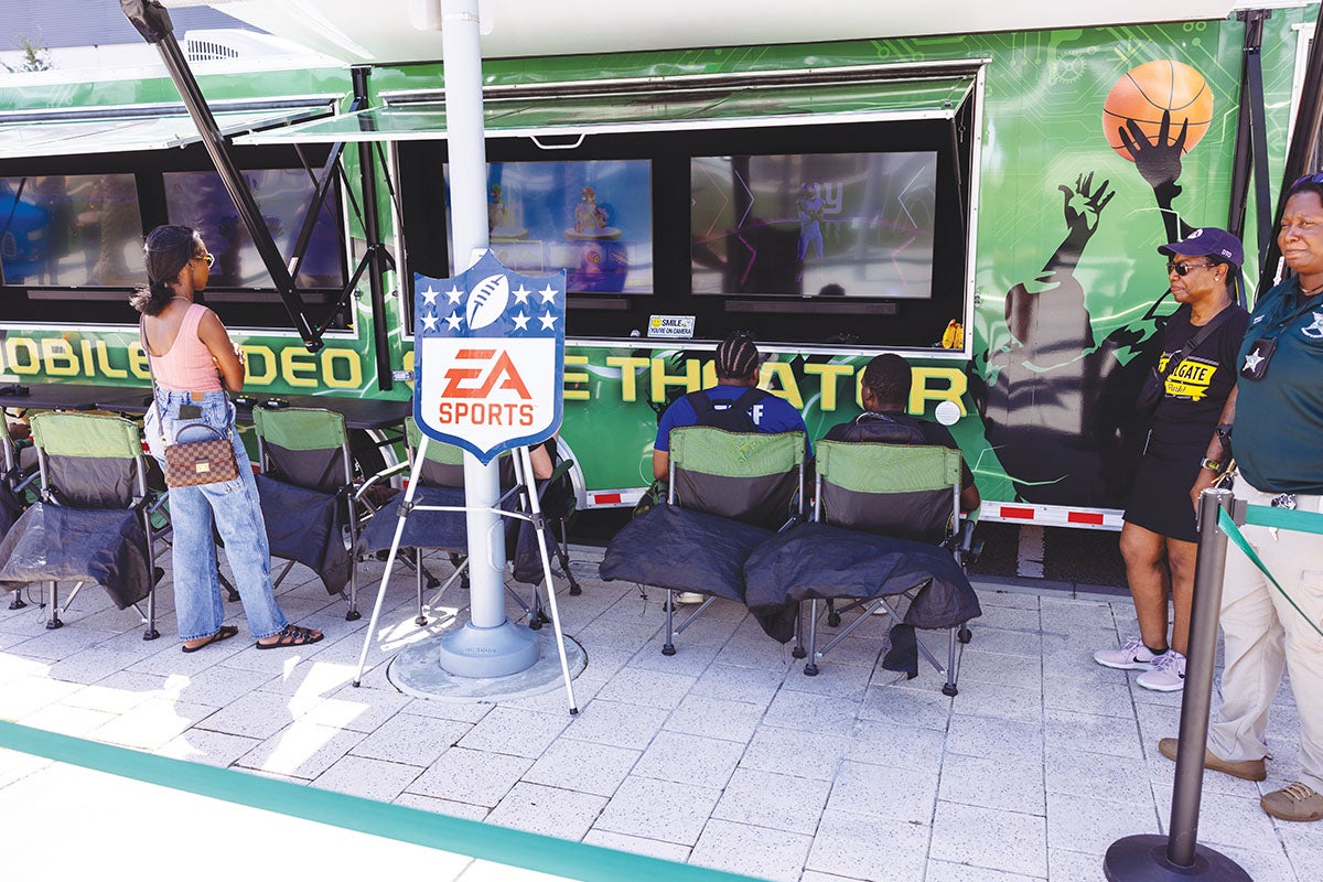 Children from the Orlando Kidz Zone program playing video games at the EA SPORTS trailer.