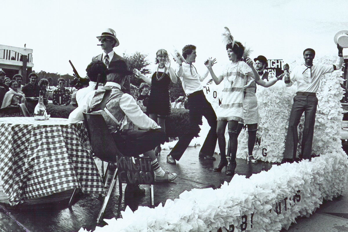 A black and white photo of students attending a homecoming event