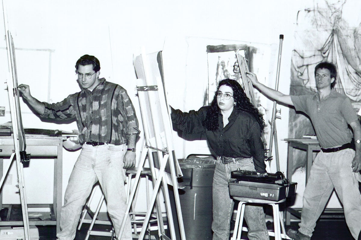 A black and white photo of students drawing during an art class