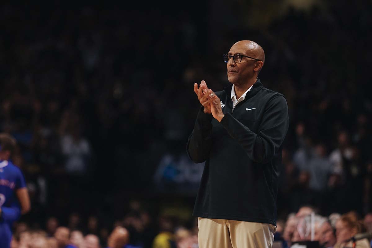 UCF men’s basketball head coach Johnny Dawkins claps his hands, cheering on the Knights to victory.
