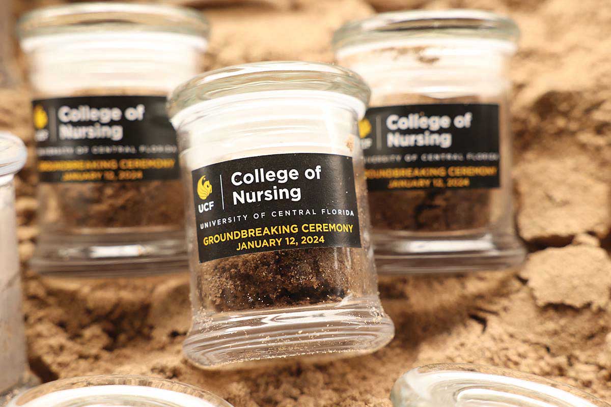 Three glass jars filled with dirt from the Dr. Phillips Nursing Pavilion groundbreaking ceremony at Lake Nona.