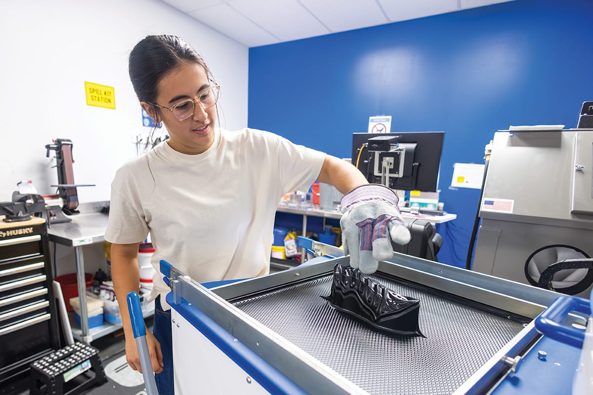 A student working in a lab with safety gear